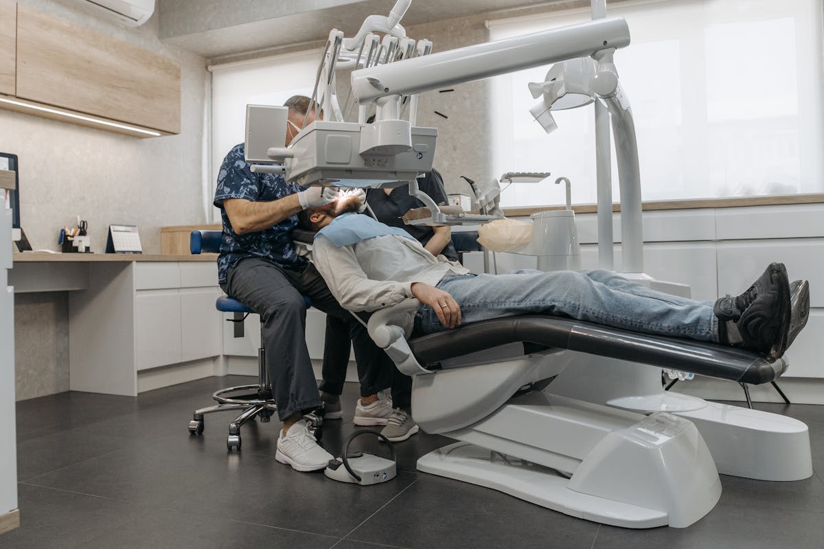 A Dentist in a Clinic Working on a Patient A Dentist in a Clinic Working on a Patient