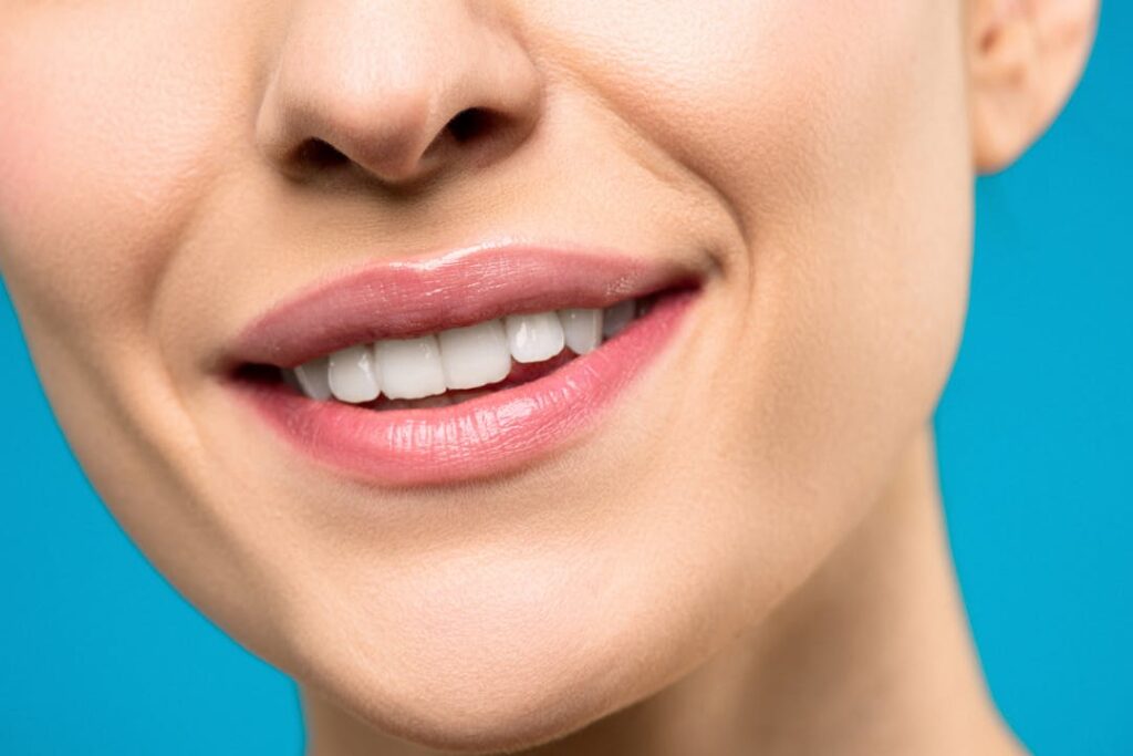 Close-up Photo of Woman With Pink Lipstick Smiling