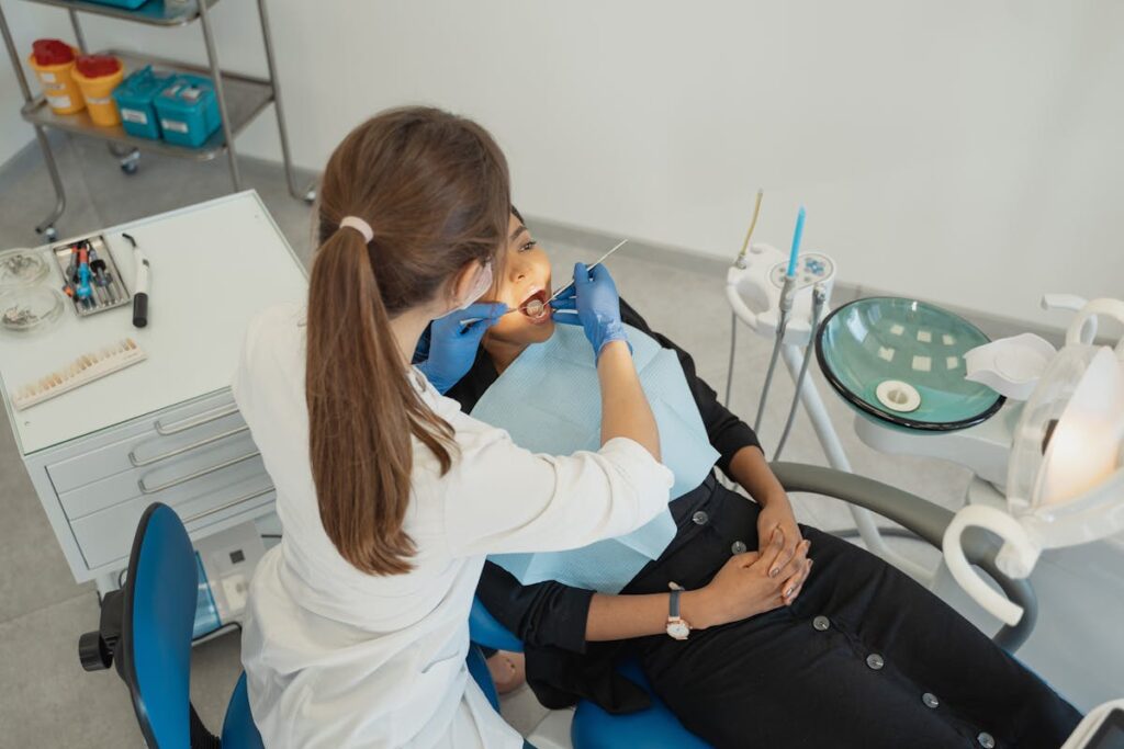 Woman in White Long Sleeve Shirt Checking the Teeth