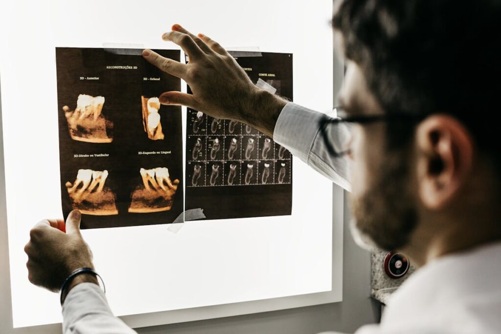 Dentist analyzing dental x-rays to assess patient teeth health in a clinical setting.