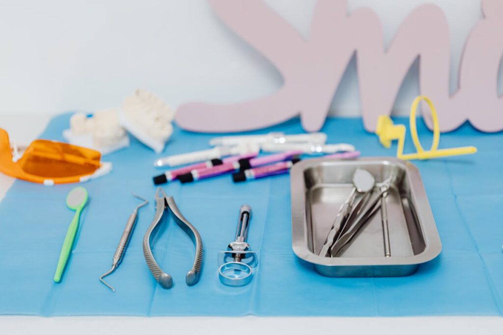 A set of dental tools neatly arranged on a blue mat, emphasizing modern dentistry.