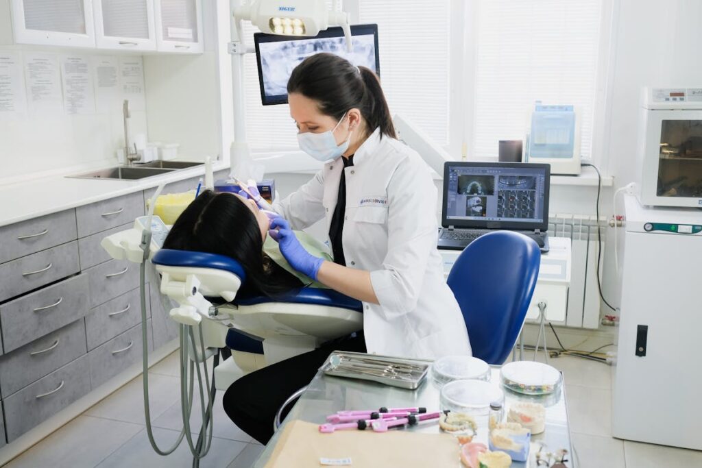 A dentist provides care to a patient in a modern dental clinic setting.
