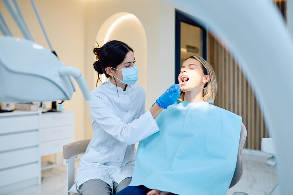 Dentist examining patient during routine dental checkup