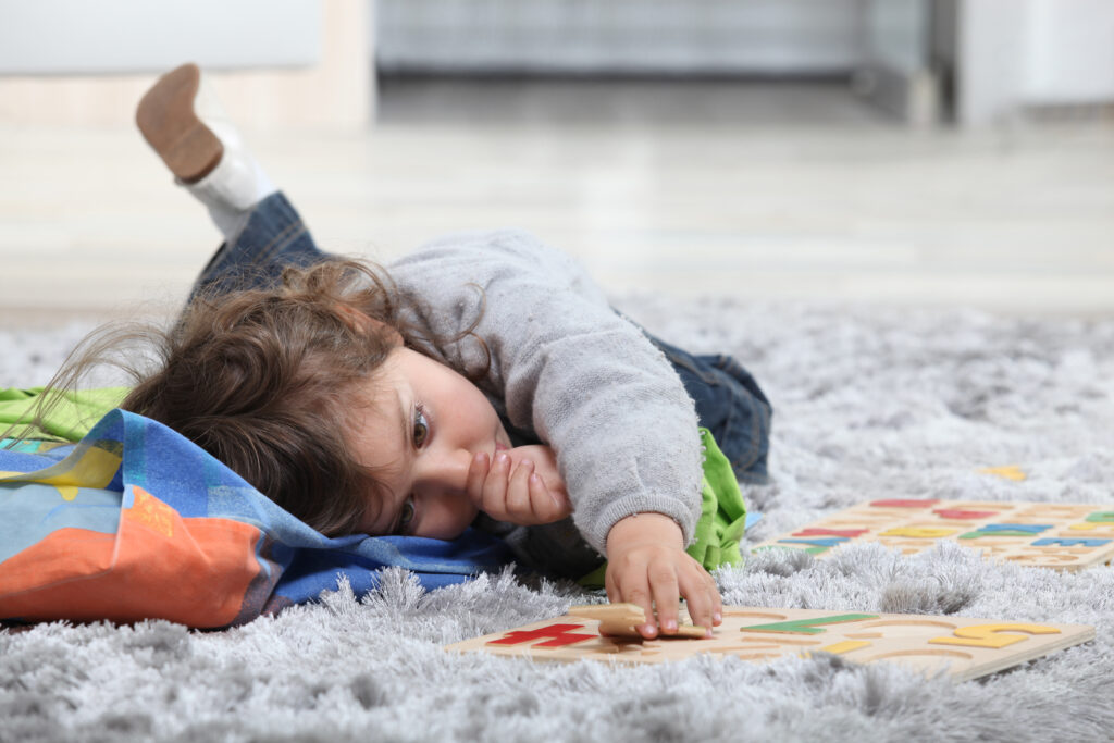 toddler playing and sucking thumb