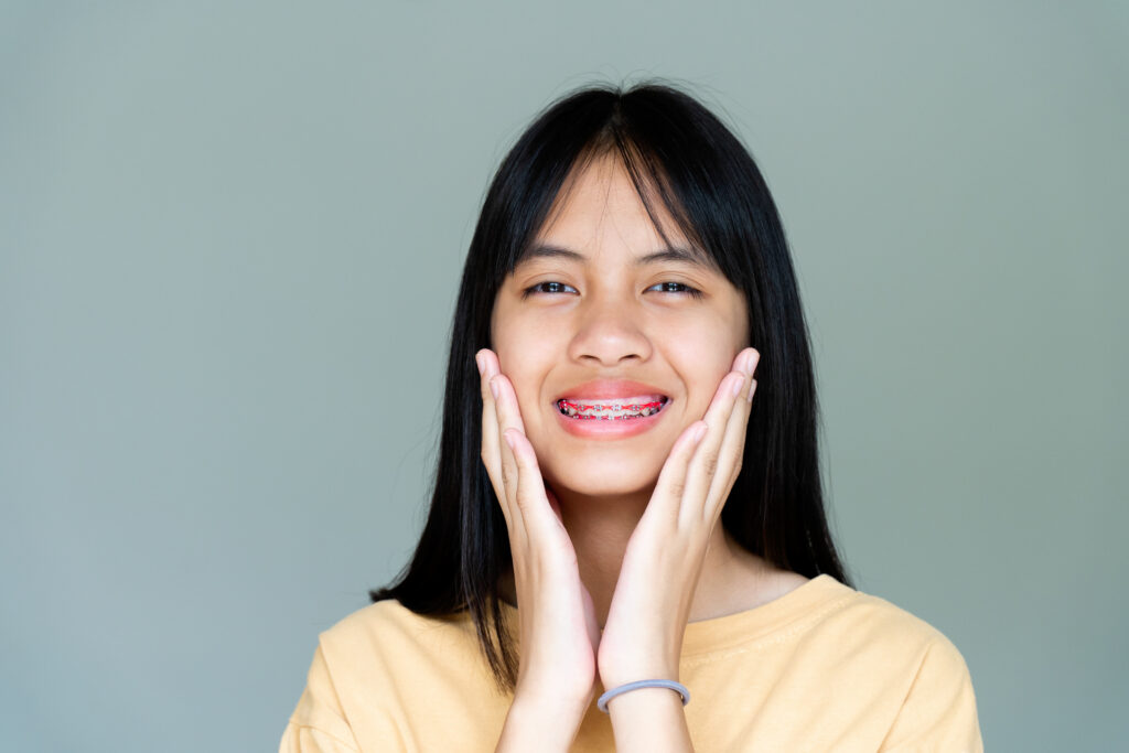 Dental Brace Girl Smiling and Looking to Camera, She Feel Happy and Have Good Attitude with Dentist. Motivate Kids not Fear When they have to go to Dental Clinic.