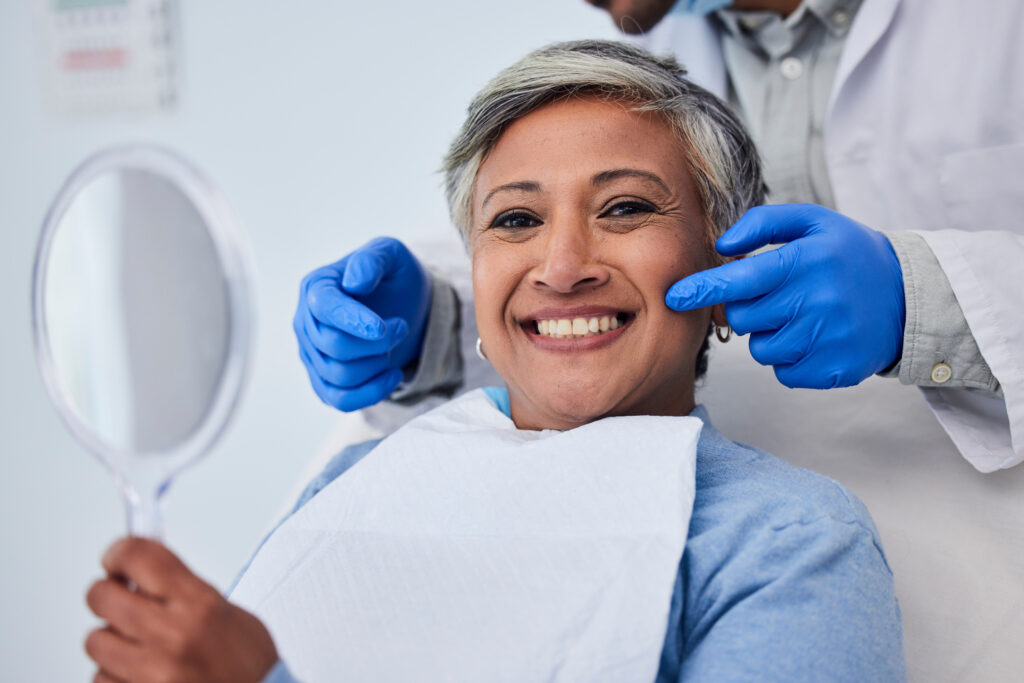 Happy senior woman, teeth and dentist for dental care, appointment or checkup at clinic. Portrait of elderly female person smile for tooth whitening, cleaning or oral, mouth and gum care at hospital.
